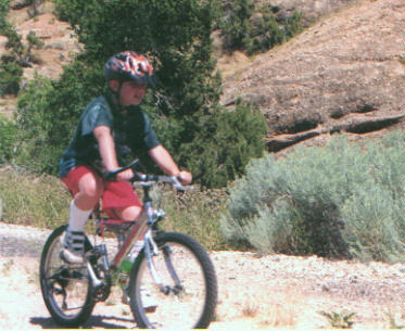 Alex rides along the rock mountains near Echo Lake